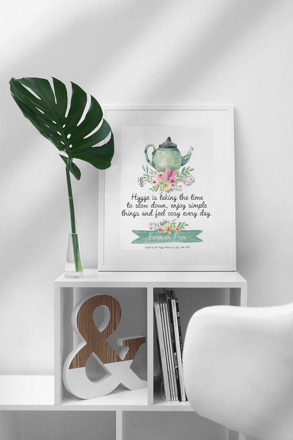 mockup-featuring-a-picture-frame-standing-on-top-of-a-small-white-bookcase-499-el